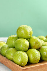 Fresh Green Plums with Water Droplets on Wooden Board - Healthy Organic Fruit