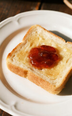 A single piece of toast with raspberry jam. Ai