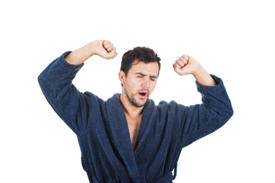 Sleepy young man yawning and streatching early in the morning. Male portrait wearing bathrobe isolated on transparent background
