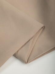 Light, dense fabric for sewing clothes, ironed, the texture of the fabric is visible