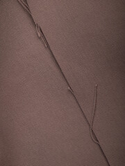 Dark dense fabric for sewing clothes, ironed, the texture of the fabric is visible