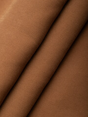 Dark dense fabric for sewing clothes, ironed, the texture of the fabric is visible