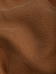 Dark dense fabric for sewing clothes, ironed, the texture of the fabric is visible