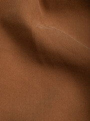 Dark dense fabric for sewing clothes, ironed, the texture of the fabric is visible