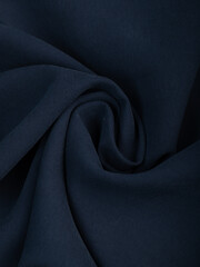 Dark dense fabric for sewing clothes, ironed, the texture of the fabric is visible