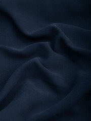 Dark dense fabric for sewing clothes, ironed, the texture of the fabric is visible
