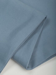 Light blue dense fabric, ironed, the texture of the fabric is visible