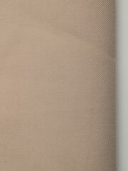 Light, dense fabric for sewing clothes, ironed, the texture of the fabric is visible