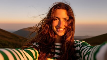 One woman, portrait of a young female hiker taking a selfie high on mountain in sunset