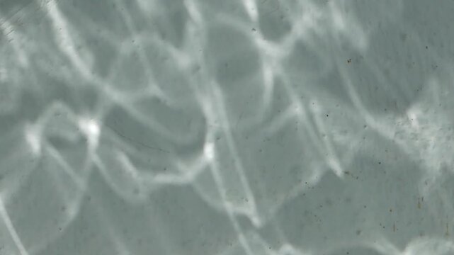 The reflection of water on a white wall.