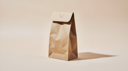 Compostable sugarcane clamshell takeout box on a light warm gray background, clean eye-level studio shot with soft grounded shadow