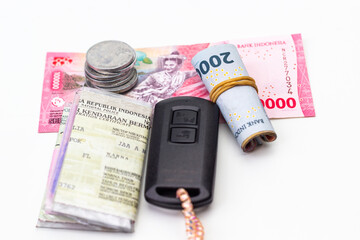 Indonesian Rupiah Currency with Vehicle Documents and Remote Car Key Depicts Financial Stability and Ownership, Symbolizing Economic Activity in Asia and Indonesian Identity