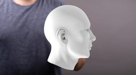 Stock photo of a person holding a white 3D model of a human head.  Perfect for AI, technology, and healthcare concepts.