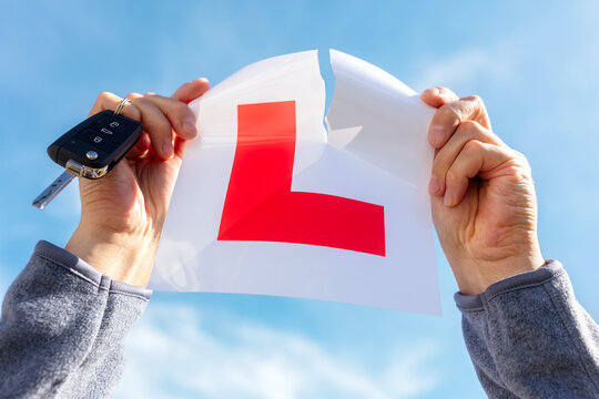 Fototapeta Tearing up L plate after passing driving test