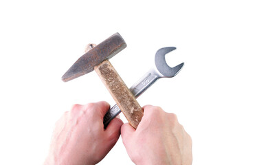 Hands holding a hammer and a wrench on a white background