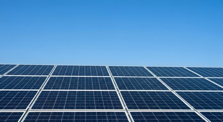 Obraz premium Array of Solar Panels Against a Clear Blue Sky Promoting Sustainable Energy