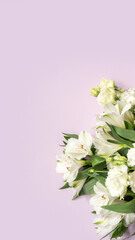 White lilies and carnations on pastel purple background