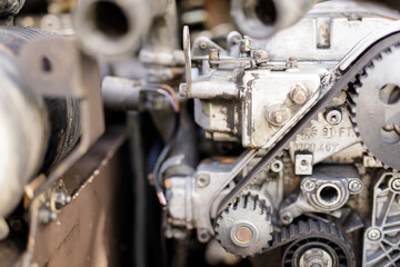 Detailed image of old, rusty engine components, gears, and belts. Ideal for mechanics, industrial, and automotive projects.