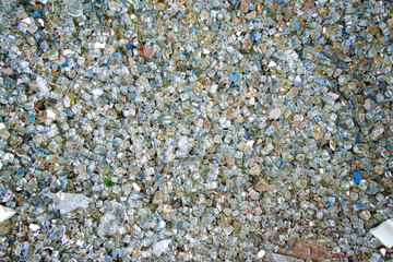Broken glass fragments glistening, symbol of recycling and eco-friendly concepts. Perfect texture for environmental campaigns, green economy visuals and sustainability projects. Conscious design