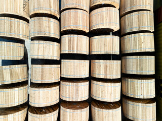 Loading of wooden cable reels and industrial containers. Aerial image showing a large quantity of large wooden reels arranged in neat rows, ready for transport or storage.