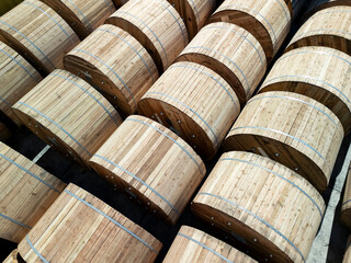 Loading of wooden cable reels and industrial containers. Aerial image showing a large quantity of large wooden reels arranged in neat rows, ready for transport or storage.