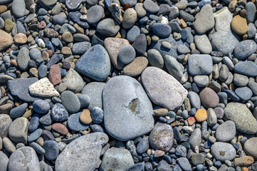 Sea stones on Cyprus beach as natural background