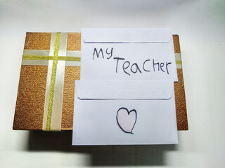 A special gift for teachers day, a beautifully wrapped present with a heartfelt note and a drawn heart, expressing gratitude and appreciation