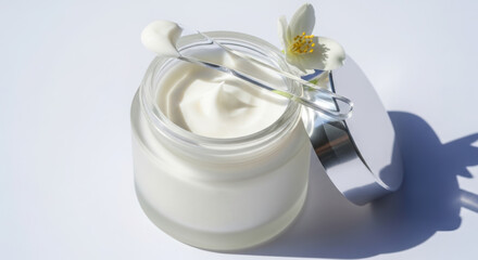 Luxurious facial cream in glass jar with jasmine flower showcasing smooth texture perfect for beauty and skincare advertising