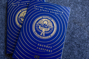 Kyrgyz Republic passports on gray fabric background