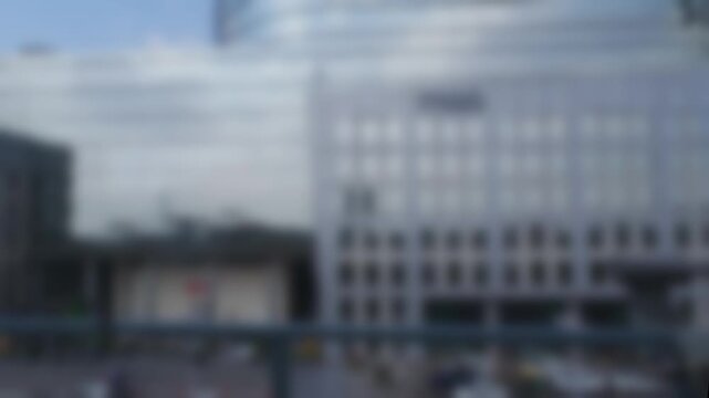 Blurred panoramic view of the buildings in DLF Cyber City from the window of the subway train at a sunny day in Gurugram, India. Bokeh real time motion video
