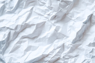Obraz premium Crumpled white paper texture in natural light setting