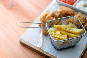 French Fries and Fried Fish Served on Wooden Board