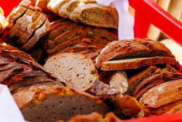 Variety of freshly baked artisan bread displayed in a red basket
