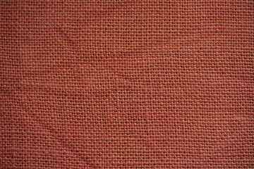 Fototapeta premium orange burlap fabric texture – close-up background top view 
