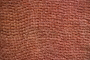 Fototapeta premium orange burlap fabric texture – close-up background top view 