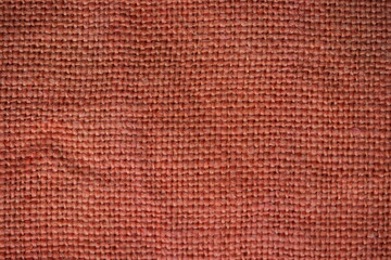 Fototapeta premium orange burlap fabric texture – close-up background top view 