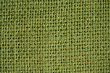 light green bfabric canvas burlap  pistachio burlap fabric texture – close-up background top view 