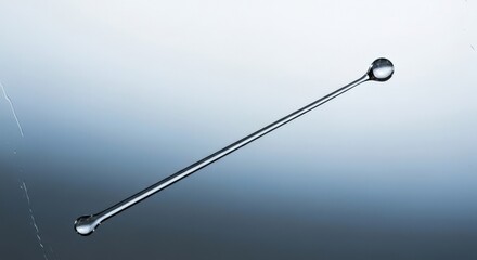 Water Droplet on a Thin Glass Rod Captured to Showcase Fluid Dynamics and Minimalist Aesthetics