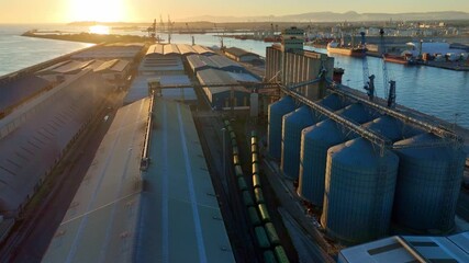 Cargo port at sunset, aerial view of industrial port in Spain, marine logistics