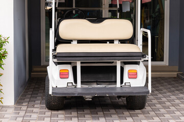 An electric golf cart is charging at home,Charging Electric Vehicle From Wall Socket at Winter.charging electric car. golf cart charging.