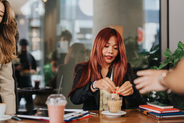 Professionals in a lively cafe environment sharing ideas and enjoying beverages while discussing work.