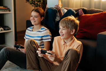 Generation z children having fun playing video games at home