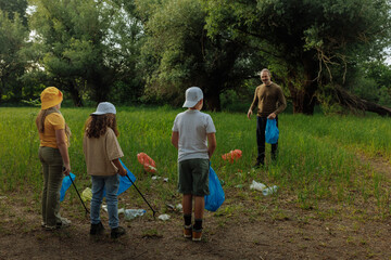 Volunteers and Teacher Collecting Trash in a Forest