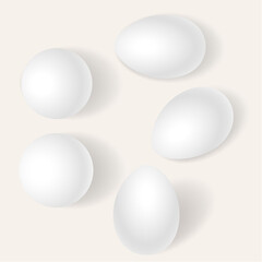 Five white round objects arranged in a circular pattern on a light background.