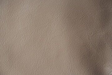 beige leather texture close-up, seams on leather jacket as background, beige natural leather as background, light brown leather stitching	
