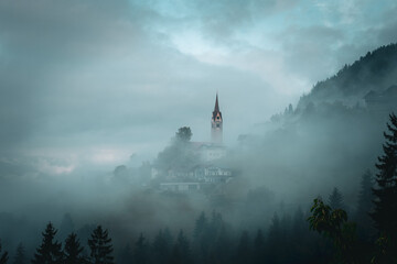 Wolkenverhangene Kirche in den Bergen von S&uuml;dtirol