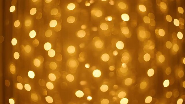 Abstract golden bokeh shimmering lights creating a dense, sparkling curtain effect, a seamless and luxurious video loop texture, celebration, glow