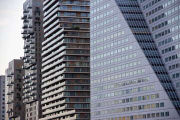 Modern urban architecture featuring a mix of residential high-rise buildings and sleek glass skyscrapers, showcasing contemporary design and city life dynamics