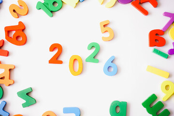 Cheerful colorful wooden blocks forming 2026, capturing the transition from 2025 and the joyful spirit of the New Year