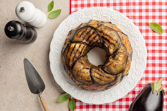 Top view of Eggplant Timbale or Timballo di Melanzane. Grilled eggplants wrap around the pasta and tomato, cheese sauce, and baked.